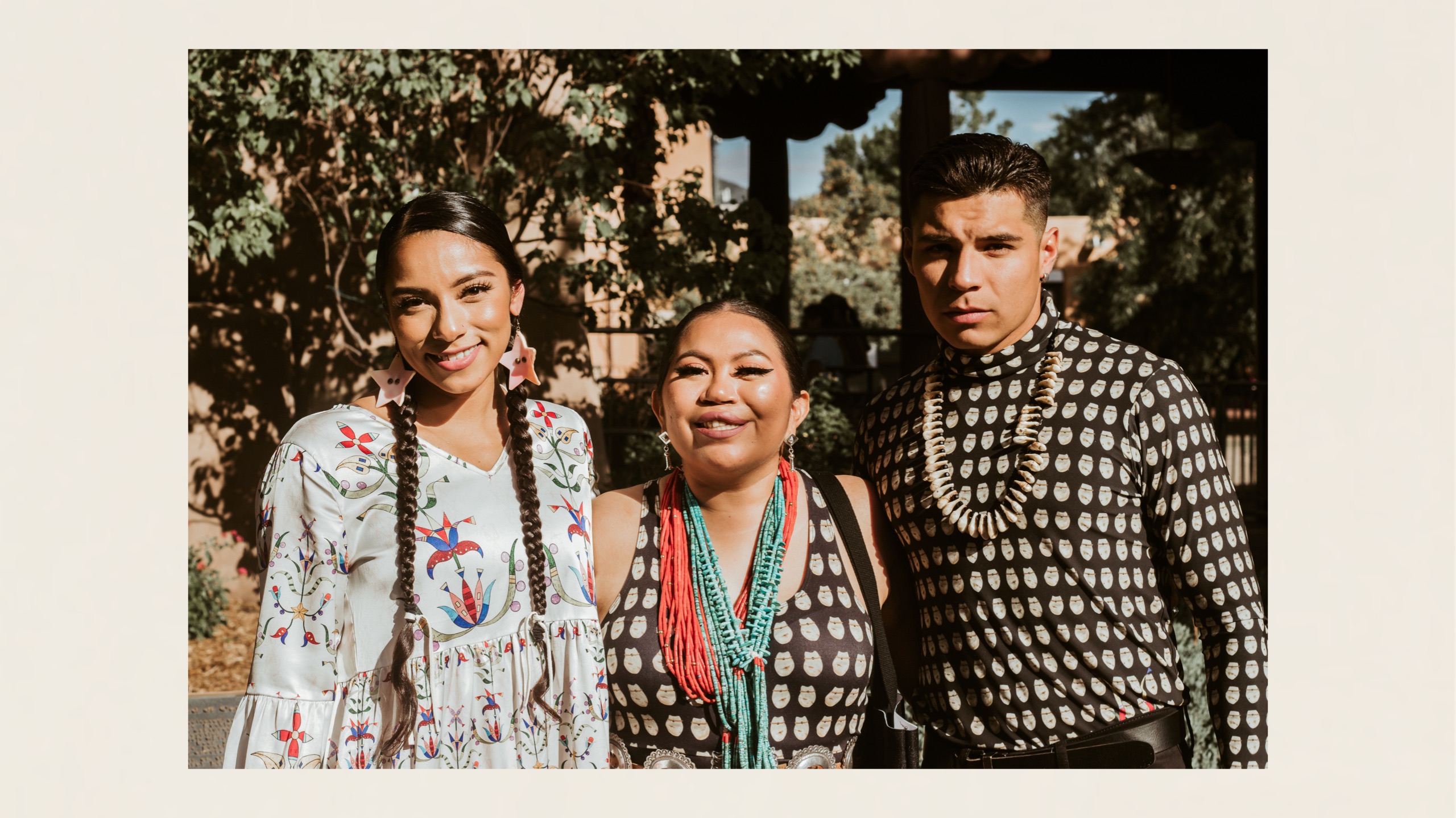 Jayli Fimbres, Naiomi Glasses, and Tavares Andres dressed in designs by Lauren Good Day at the 100th Annual Santa Fe Indian Fashion Show
